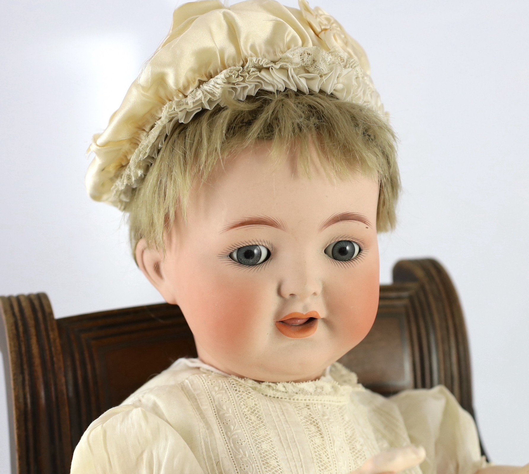 A Kammer & Reinhardt / Simon & Halbig bisque character doll, German, circa 1914, 20in. Please note the chair is for display purposes only.